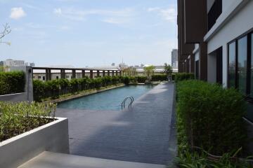 Outdoor swimming pool area with surrounding greenery