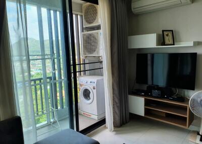 Living area with balcony view, air conditioning, and entertainment setup