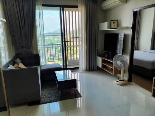 Modern living room with large window and balcony view