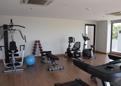 Well-equipped fitness room in the residency includes various exercise machines and equipment.