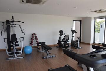 Well-equipped fitness room in the residency includes various exercise machines and equipment.