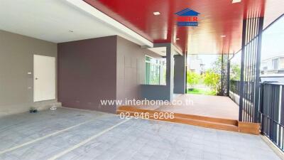 Front view of a modern residential building with a carport and entryway.