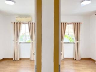 Bedroom with wooden flooring and windows with curtains