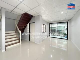 Main living space with staircase and large window