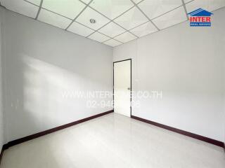 Empty room with tile flooring and a white door