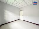 Empty room with tile flooring and a white door
