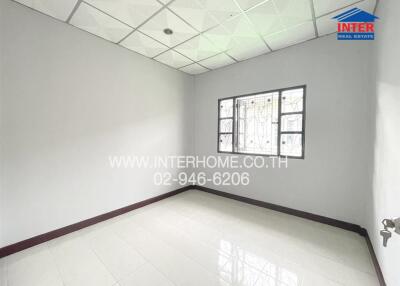 Empty unfurnished bedroom with tiled floor and window