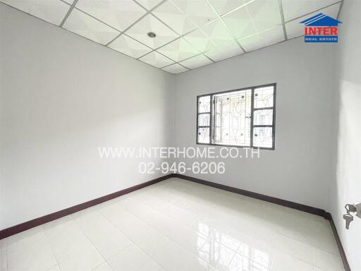 Empty unfurnished bedroom with tiled floor and window