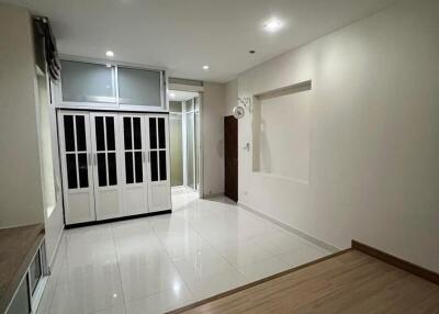 modern main living space with wood and tile flooring, built-in storage, and recessed lighting