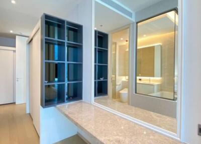 Modern bathroom with a large mirror and storage compartments