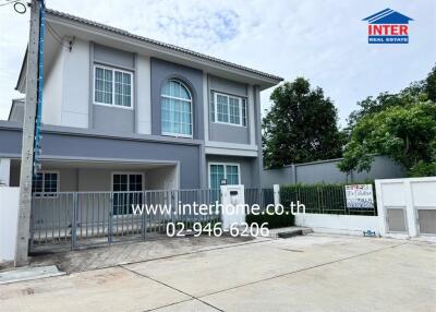 Two-story modern house with gated entrance