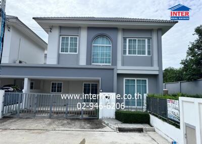 Front view of a two-story house with a grey and white exterior