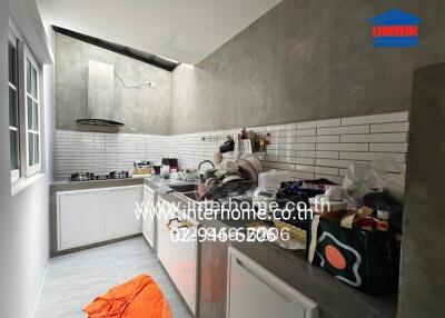 Modern kitchen with white cabinets and tiled backsplash