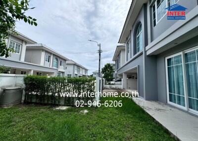 Exterior view of residential buildings with green yard