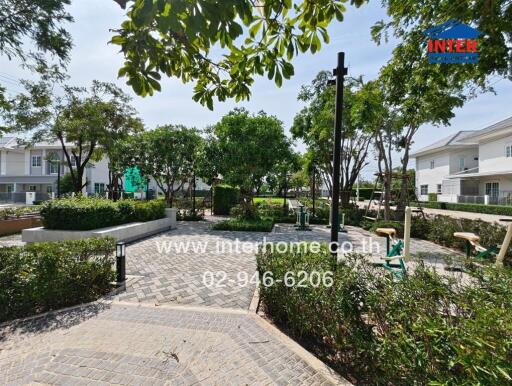 Outdoor community garden with exercise equipment and walking paths