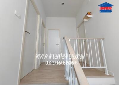 hallway with multiple doors and stairs