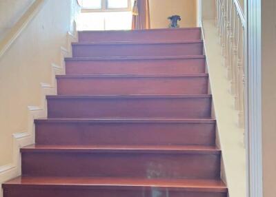 Interior staircase with wooden steps and decorative railing