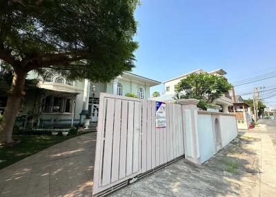 Exterior view of a residential house with gated entrance