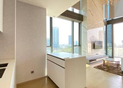 Modern high-rise apartment with a kitchen and living area featuring large windows and city views