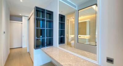 Modern bathroom with large mirrors, a vanity area, and integrated shelving