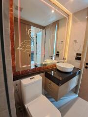 Modern bathroom with illuminated mirror and stylish basin