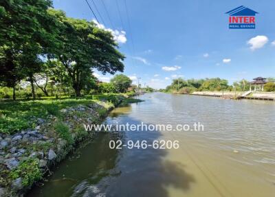 Scenic riverside view with trees, clear sky, and calm water