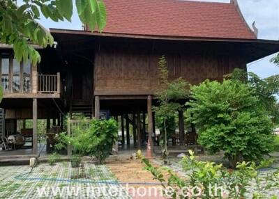 Exterior view of traditional Thai house with garden