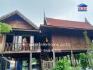 Traditional Thai wooden house with elevated structure and gabled roofs