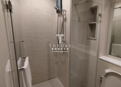 modern bathroom with glass shower and wall-mounted television