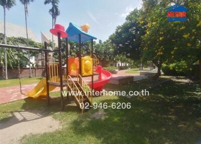 Outdoor playground area with slide and swings