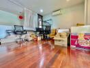 Room with wooden flooring and scattered boxes