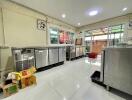 Modern kitchen with stainless steel appliances and gleaming white tile floor