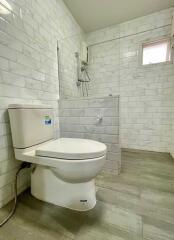 Modern bathroom with a tiled shower and toilet