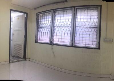 Empty room with barred windows and a door