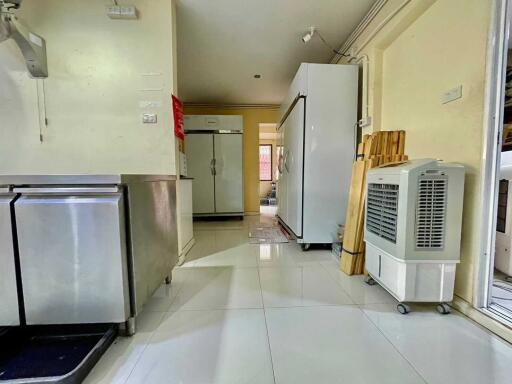 Modern kitchen with stainless steel appliances and clean, bright flooring