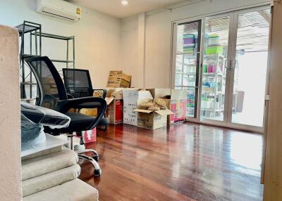 Room with office chairs, cardboard boxes, and sliding glass doors