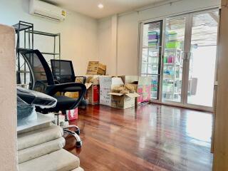 Room with office chairs, cardboard boxes, and sliding glass doors