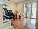 Room with office chairs, cardboard boxes, and sliding glass doors