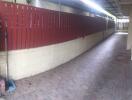 Covered walkway with red wooden fence