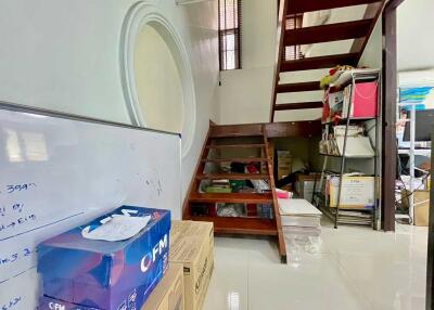 Storage area under a staircase with whiteboard and boxes