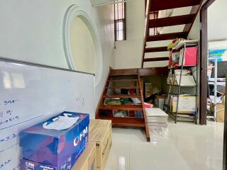 Storage area under a staircase with whiteboard and boxes