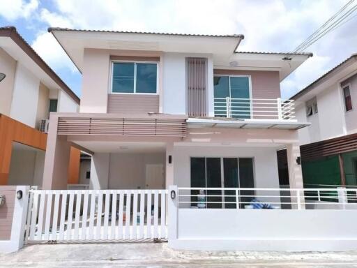 Two-story modern house with gated front yard