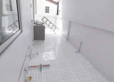 Bright and airy laundry area with tiled flooring