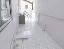 Bright and airy laundry area with tiled flooring