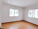 Bright bedroom with wooden floor and large windows