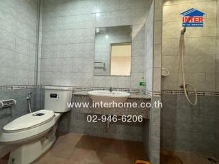 Modern bathroom with shower, sink, and toilet