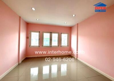 Spacious room with pink walls and large windows