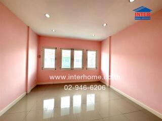 Spacious room with pink walls and large windows