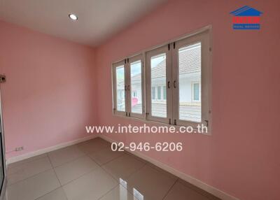 Bedroom with pink walls, tiled floor, and windows