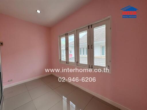 Bedroom with pink walls, tiled floor, and windows